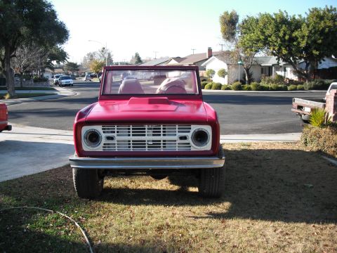 1968 Ford Bronco - Front view of a red 1968 Ford Bronco parked on a residential street.