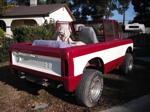 1968 Ford Bronco - This 1968 Ford Bronco is shown in a rear three-quarter view, with its doors open and interior covered.
