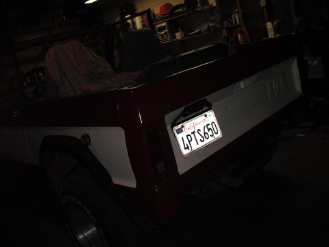 1968 Ford Bronco - The rear of a two-tone Ford Bronco is shown in a garage setting, with a license plate clearly visible.