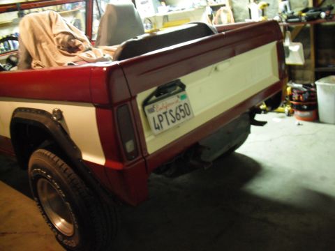 1968 Ford Bronco - This red and white pickup truck is shown from the rear, a California license plate.