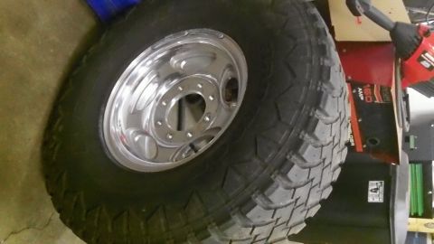 1979 Ford Bronco - A close-up of a large tire and a shiny chrome wheel is shown.
