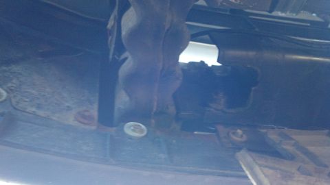 1996 Ford Bronco - Close-up of the vehicle's undercarriage, showing suspension parts and frame structure.