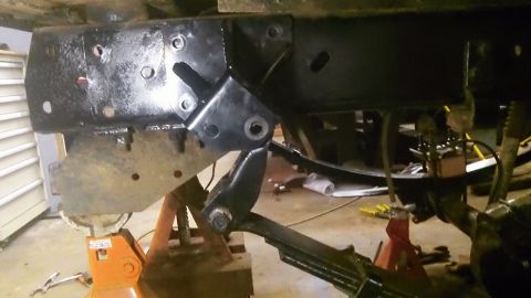 1979 Ford Bronco - Custom bracket welded to a vehicle's frame, showing suspension components and repair work.