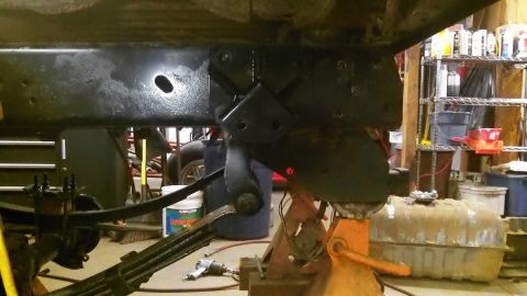 1979 Ford Bronco - Underside view of a vehicle's frame and suspension components, with a fuel tank in the foreground.