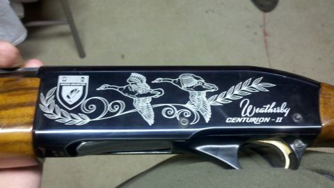 2010 Champion 188 - Engraved receiver of a Weatherby CENTURION-II shotgun flying ducks and a heraldic shield.