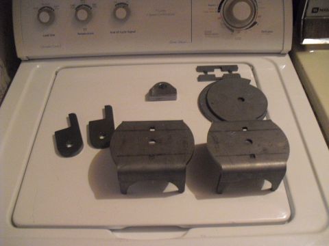 1986 Ford Bronco - Various air suspension parts are arranged on top of a washing machine.