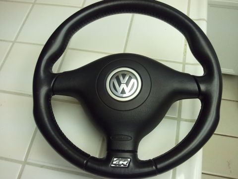 1989 Ford Bronco - A black Volkswagen steering wheel with the iconic VW emblem and an 'R' logo is shown.