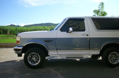 1993 Ford Bronco - This 1993 Ford Bronco is shown from the side, with a two-tone paint scheme and aftermarket wheels.
