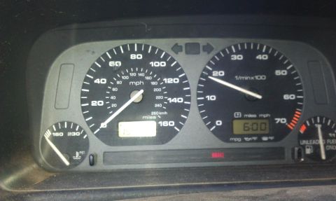 1991 Ford Festiva - The dashboard gauges show a speedometer, tachometer, and fuel level, with a digital clock displaying 6:00.