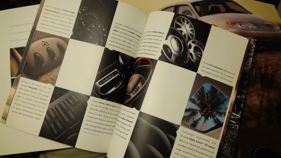 Open Lincoln Continental brochure spread with instrument cluster, wheel and console photos
