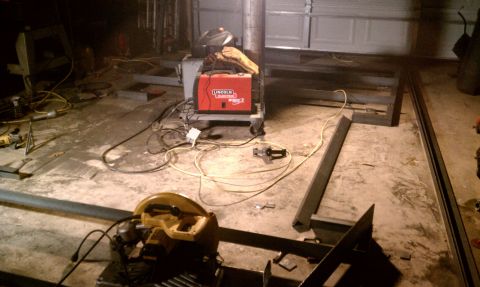 1990 Ford Bronco - Metal fabrication project underway in a garage with welding equipment and tools.