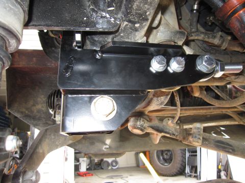 2008 Jeep Wrangler - Close-up view of aftermarket steering brace installed on vehicle suspension system.
