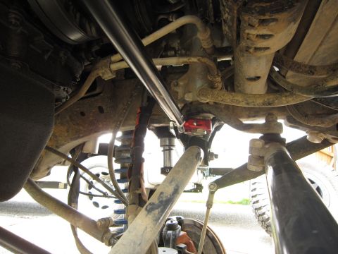 2008 Jeep Wrangler - Close-up of aftermarket steering brace and suspension components on a Jeep Wrangler.