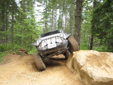2008 Jeep Wrangler - Jeep Wrangler navigating an obstacle on an off-road trail.