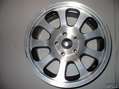 1997 Ford Taurus - Close-up of an American Racing alloy wheel with a silver finish and black inserts.