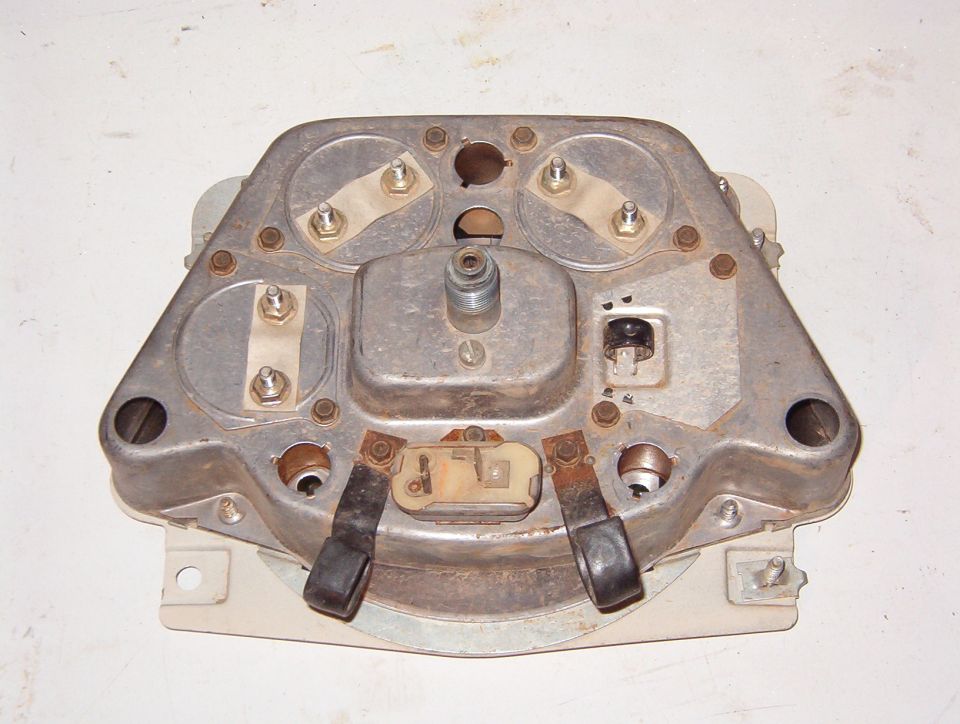 Back of a vintage instrument cluster housing showing terminals and printed circuit straps