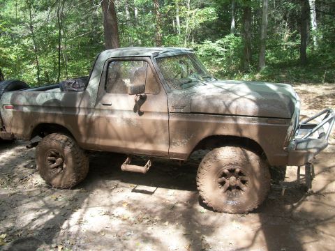 1979 Ford Bronco - This heavily soiled vehicle appears to be a Ford Bronco from the late 1970s, equipped for off-road use.