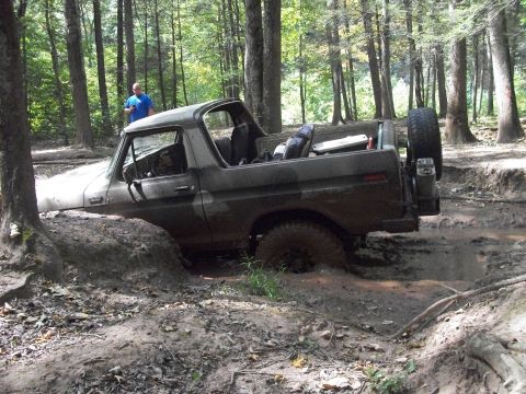 1979 Ford Bronco - This 1978 Ford Bronco is deeply embedded in a muddy trail, surrounded by trees.