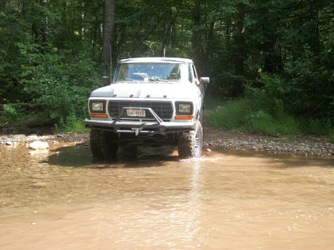 1979 Ford Bronco - This 1979 Ford Bronco navigates a shallow stream, its off-road capabilities.