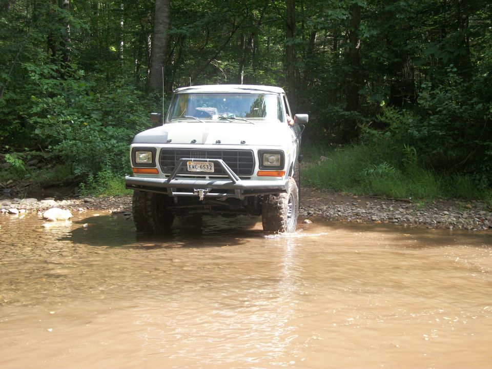 1979 Ford Bronco front view, white, driving through water