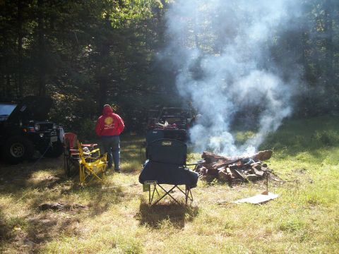 1979 Ford Bronco - Off-road vehicles and a campfire scene in a wooded area.