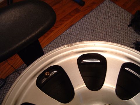 1997 Ford Taurus - A close-up view of a car wheel, showing its design and a minor imperfection on the rim.