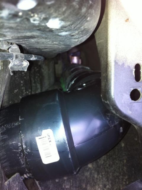 2010 Ford F-150 - Close-up of a black plastic air intake tube with a label.