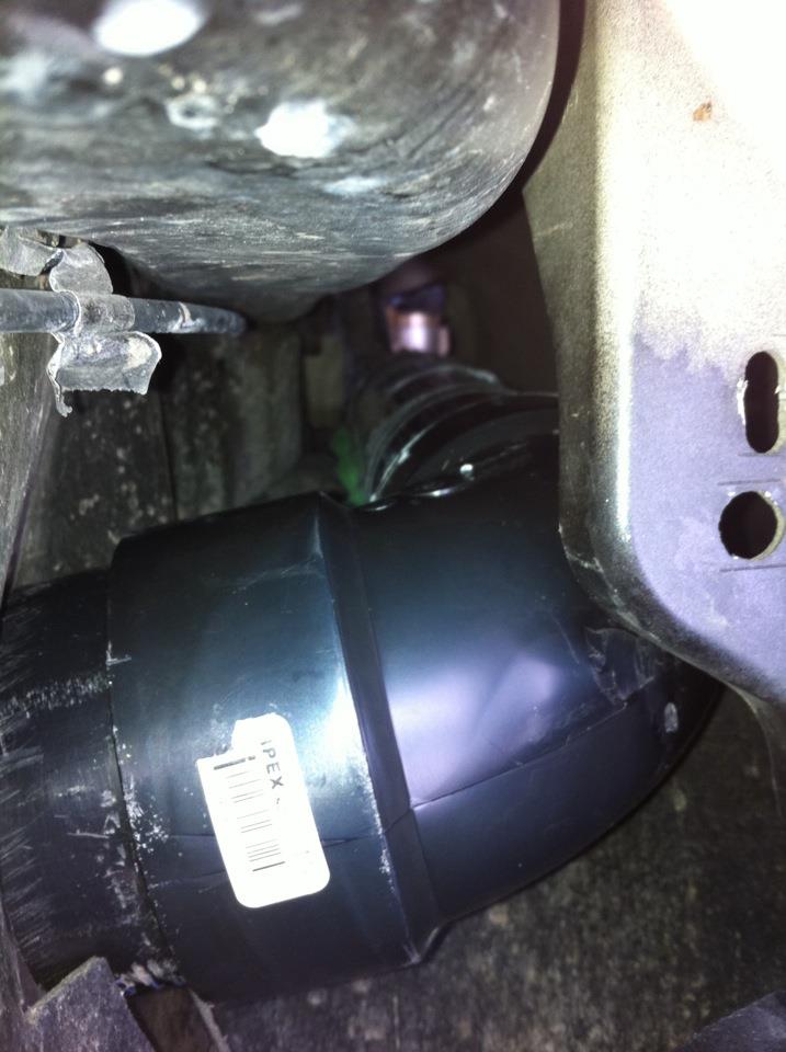 Black plastic air intake tube with a white label showing a barcode and 'IPEX -'