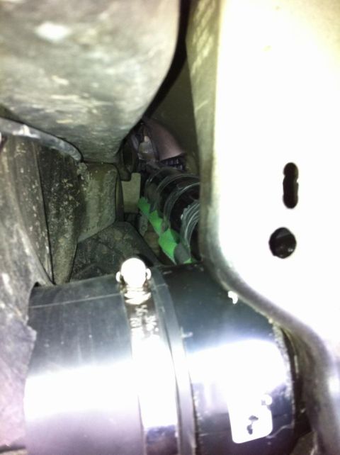 2010 Ford F-150 - A close-up view of the undercarriage of a vehicle, showing various pipes and hoses.