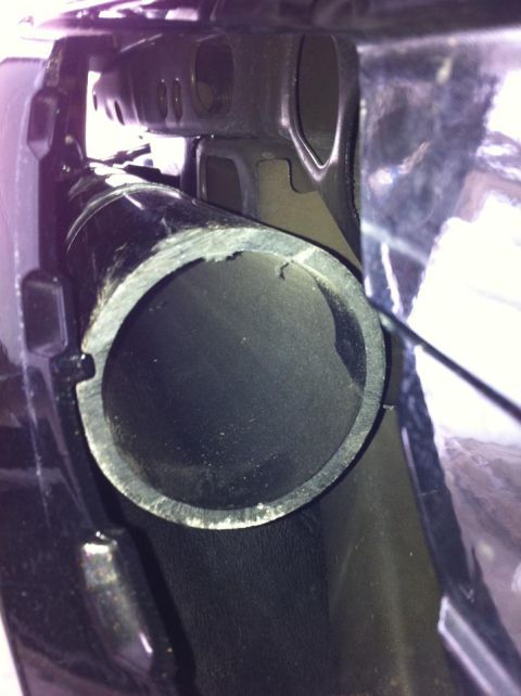 2010 Ford F-150 - Close-up of a vehicle's exhaust pipe, showing wear and tear on the opening.