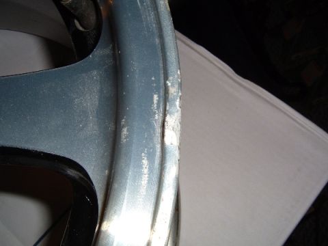 1997 Ford Taurus - A close-up view of a damaged wheel rim shows significant wear and tear.