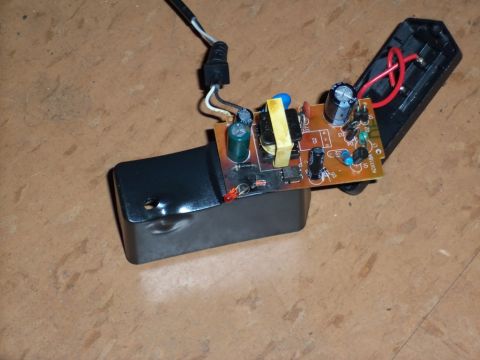 2000 Mercury Grand Marquis - A disassembled electronic power adapter reveals its internal circuit board components and wiring.