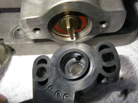 1990 Ford Bronco - The throttle position sensor assembly is shown disassembled, revealing internal components like a bearing and shaft.