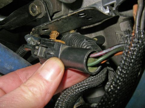 1990 Ford Bronco - Close-up of a throttle position sensor connector being held, showing internal wiring.