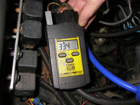 1990 Ford Bronco - OBD1 code reader connected to a vehicle's engine bay, displaying a temperature reading.