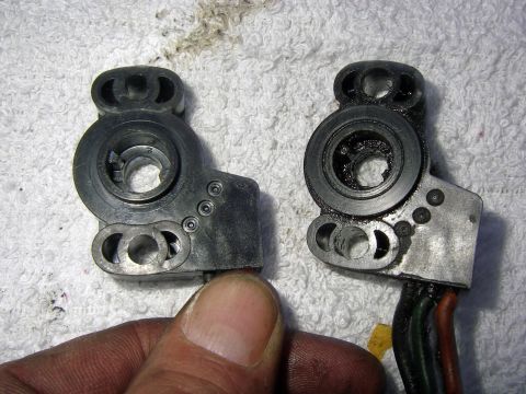 1990 Ford Bronco - Comparison of a new and used throttle position sensor, showing wear on the older part.