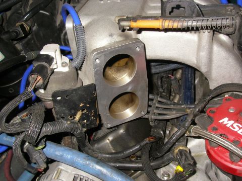1990 Ford Bronco - Close-up view of engine components, including intake manifold and ignition system parts.