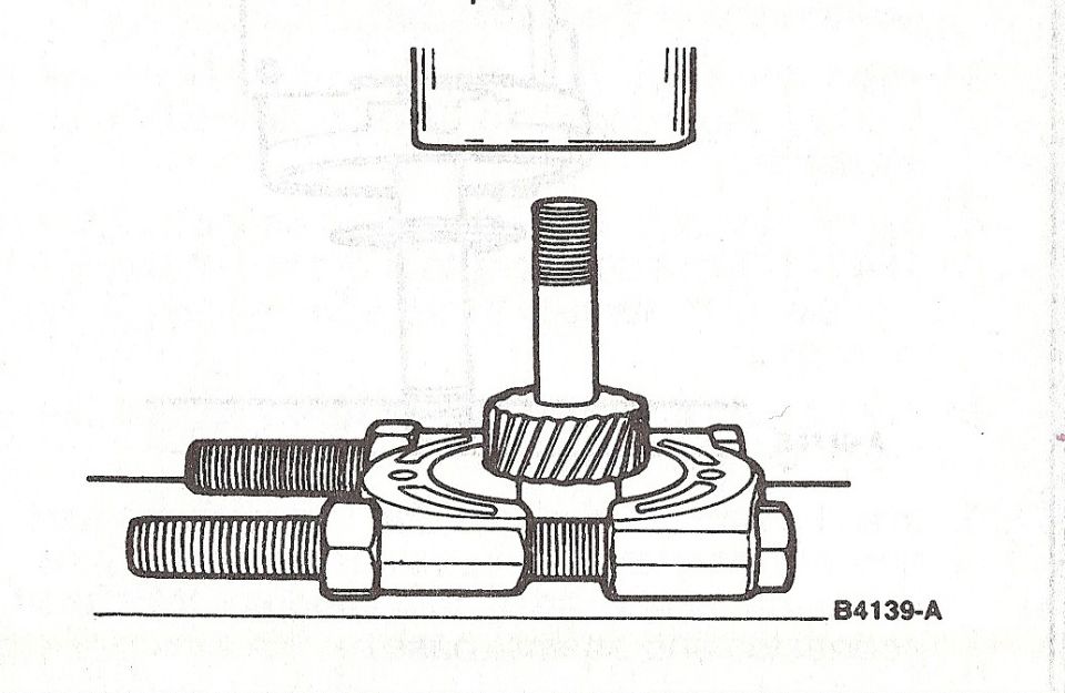 Service illustration of a splined shaft fixture held in a press with threaded studs