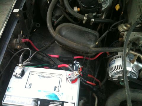 1996 Ford Bronco - Wiring for the battery and alternator in a vehicle's engine bay.