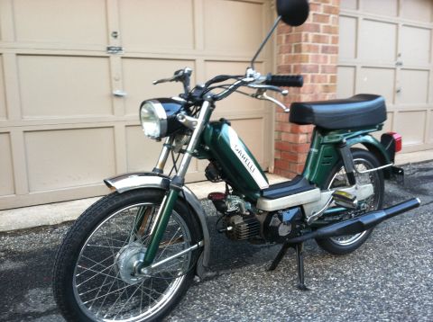 1981 Garelli Rally Sport - A green Garelli moped is parked in front of a garage door.