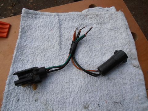 1990 Ford Bronco - A throttle position sensor wiring harness with frayed wires and connectors is shown on a white towel.