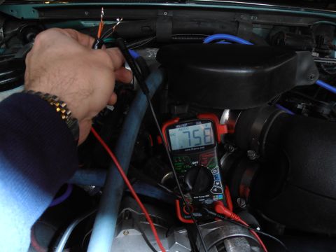 1990 Ford Bronco - Testing engine wiring with a multimeter, showing a DC voltage reading of 1.758.