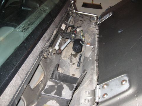2005 Jeep Wrangler - Close-up view of the windshield wiper motor and linkage assembly, likely from a Jeep Wrangler.