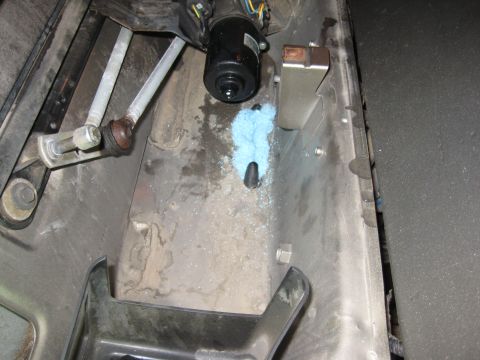 2005 Jeep Wrangler - Close-up of a vehicle's windshield wiper motor assembly and linkage.