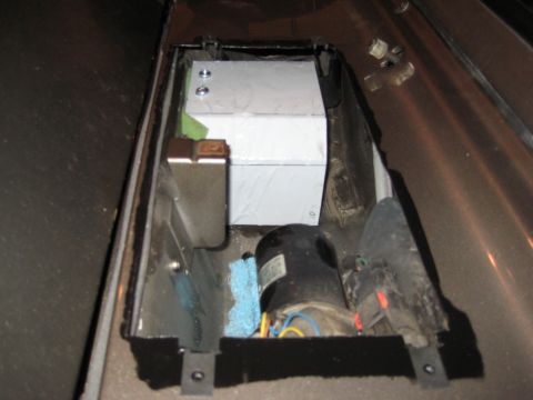 2005 Jeep Wrangler - A custom metal tank and motor assembly is visible within a vehicle's interior compartment.