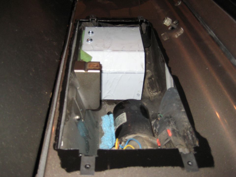Custom metal tank and motor assembly installed in a vehicle's interior compartment