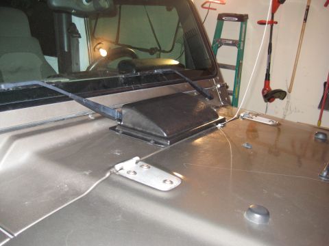 2005 Jeep Wrangler - Close-up view of the hood and windshield wiper assembly on a Jeep Wrangler.
