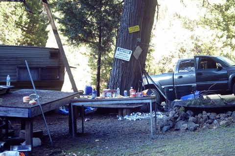 1994 Ford F-150 - A gray pickup truck and a trailer are visible at a campsite with a table set up outdoors.