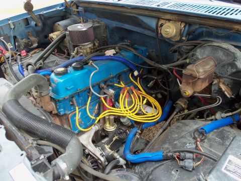 1985 Ford Bronco - Close-up view of an engine bay, showing various components and wiring.
