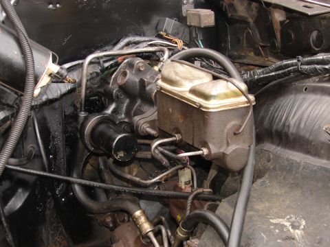 1973 Ford Ranchero - Close-up view of the brake master cylinder and power steering components within the engine bay.